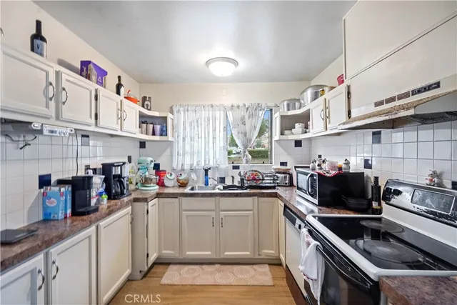 a kitchen with lots of counter top space a sink and cabinets