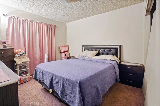 a bedroom with bed and wooden floor
