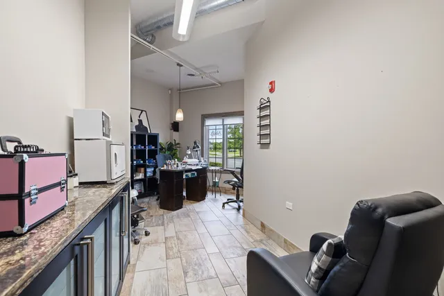 a kitchen with a refrigerator and furniture