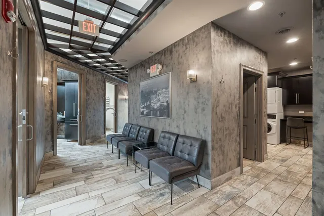 a lobby with furniture and a glass door shower