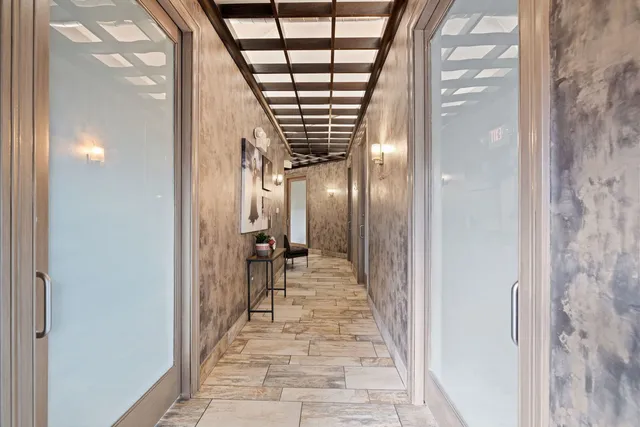 a hallway with a large window and a mirror