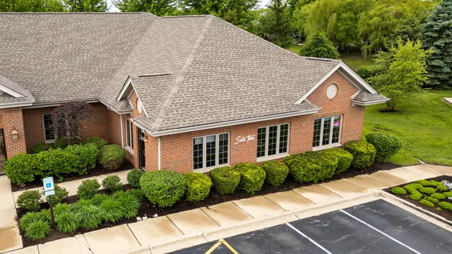 an aerial view of a house with a yard and lake view