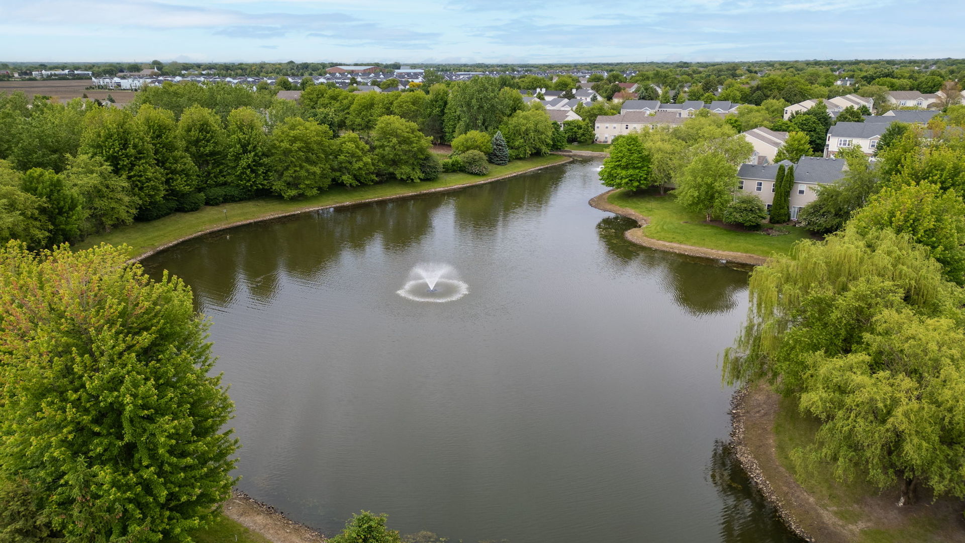 3941 75th Street, Unit 3941 Aurora, IL 60504 - Photo 24 of 25 an aerial view of a house with a yard and lake view