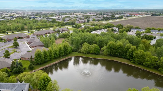 an aerial view of a house with a lake view