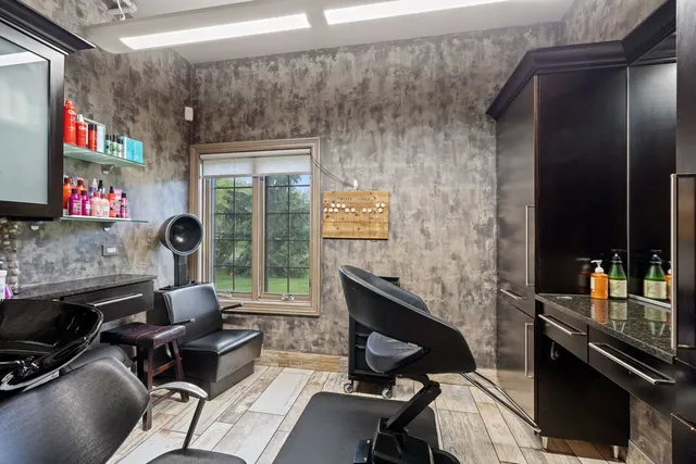 a work room with furniture and a flat screen tv