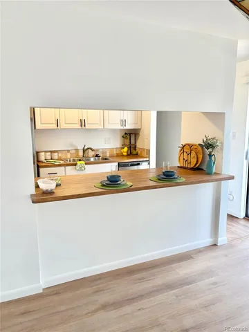 a kitchen with stainless steel appliances granite countertop a sink a stove and cabinets