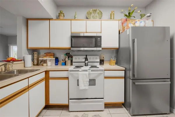 a kitchen with a refrigerator and a stove top oven
