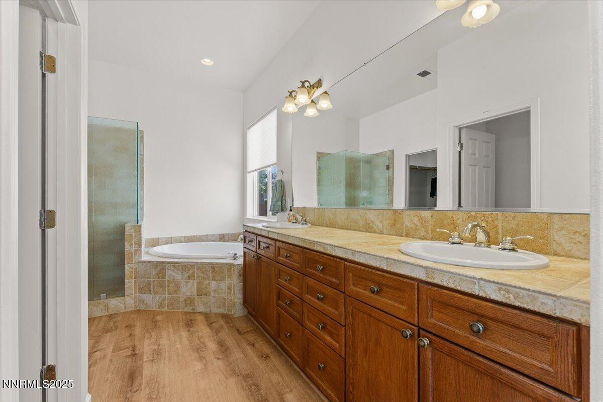 2515 Perryville Drive Reno, NV 89521 - Photo 11 of 19 a spacious bathroom with a granite countertop sink a mirror and a bathtub