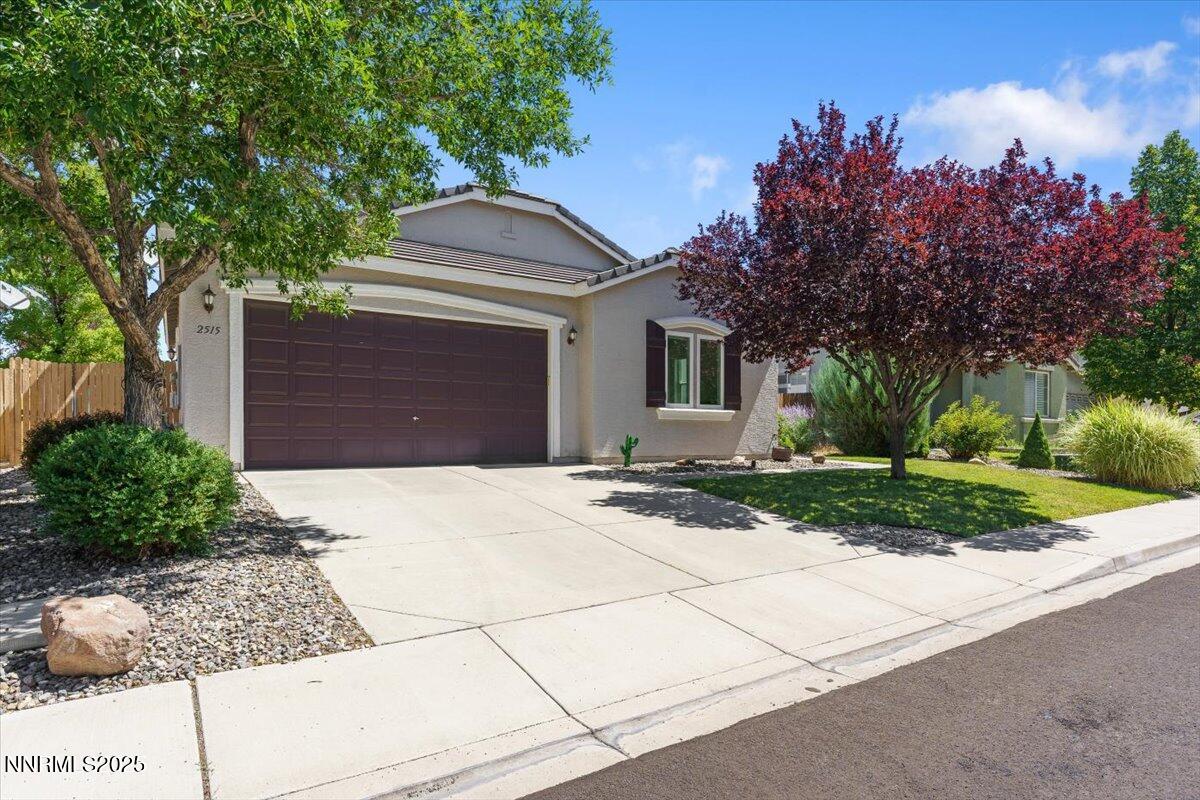 2515 Perryville Drive Reno, NV 89521 - Photo 2 of 19 a front view of a house with a yard and garage