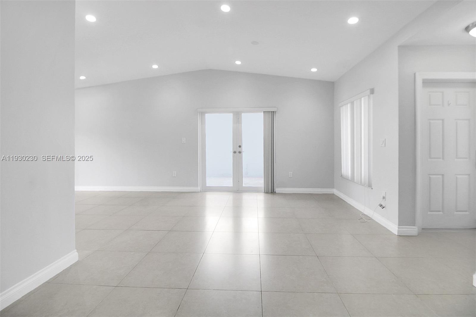 1022 Southwest 138th Place Miami, FL 33184 - Photo 13 of 39 a view of an empty room with wooden floor