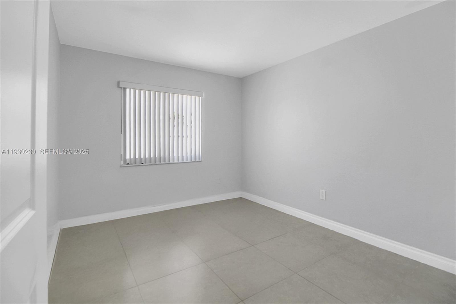 1022 Southwest 138th Place Miami, FL 33184 - Photo 18 of 39 an empty room with a window