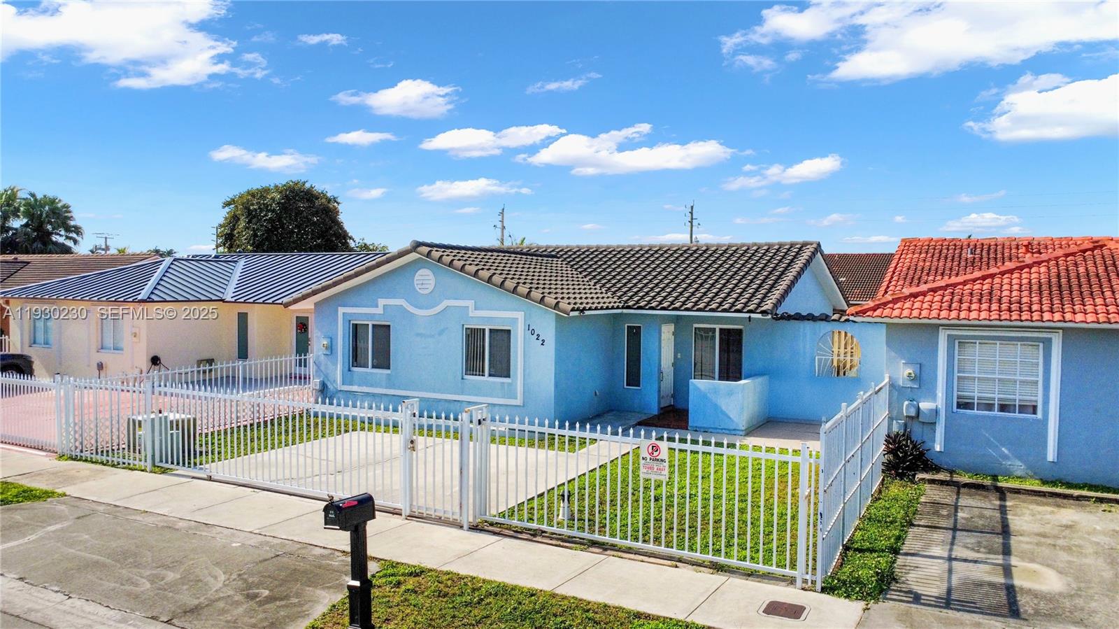 1022 Southwest 138th Place Miami, FL 33184 - Photo 2 of 39 a front view of a house with a garden and yard