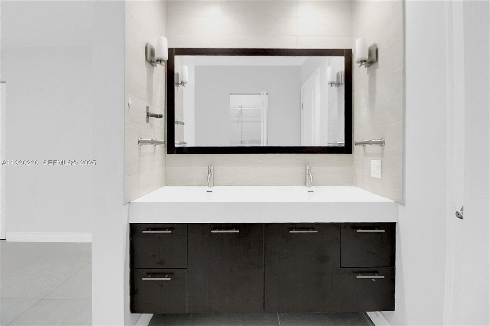 1022 Southwest 138th Place Miami, FL 33184 - Photo 28 of 39 a bathroom with a sink and a mirror