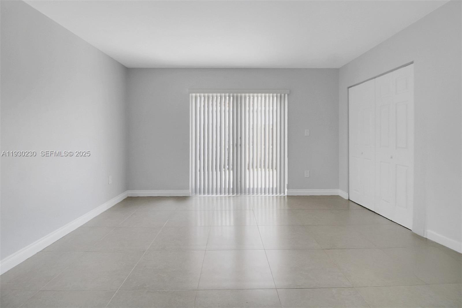 1022 Southwest 138th Place Miami, FL 33184 - Photo 29 of 39 an empty room with wooden floor and windows