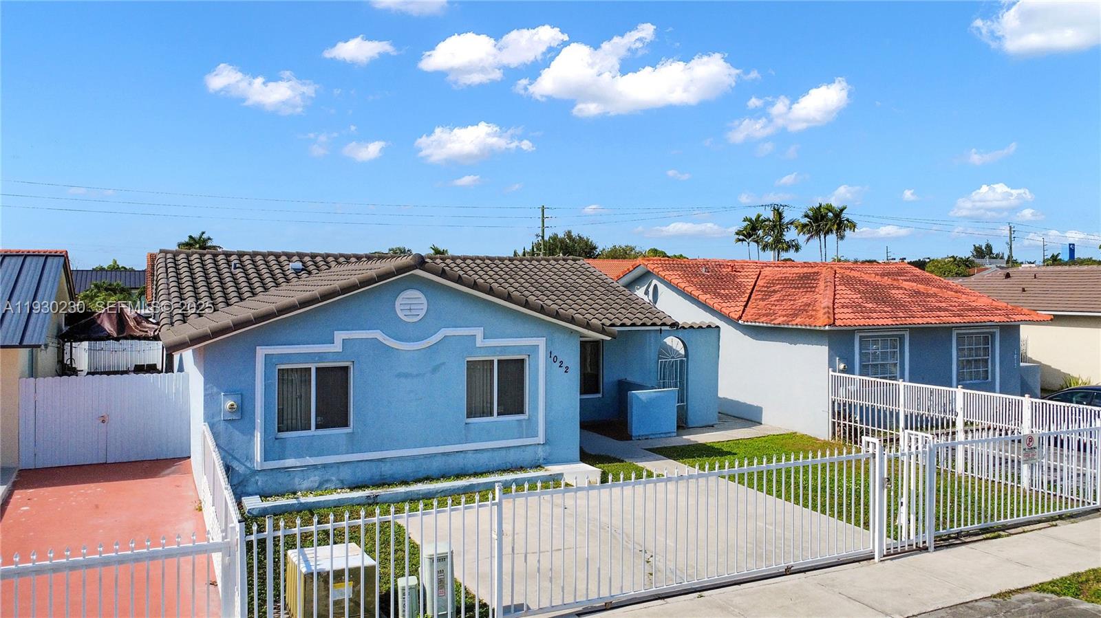 1022 Southwest 138th Place Miami, FL 33184 - Photo 4 of 39 a front view of a house with a garden and plants