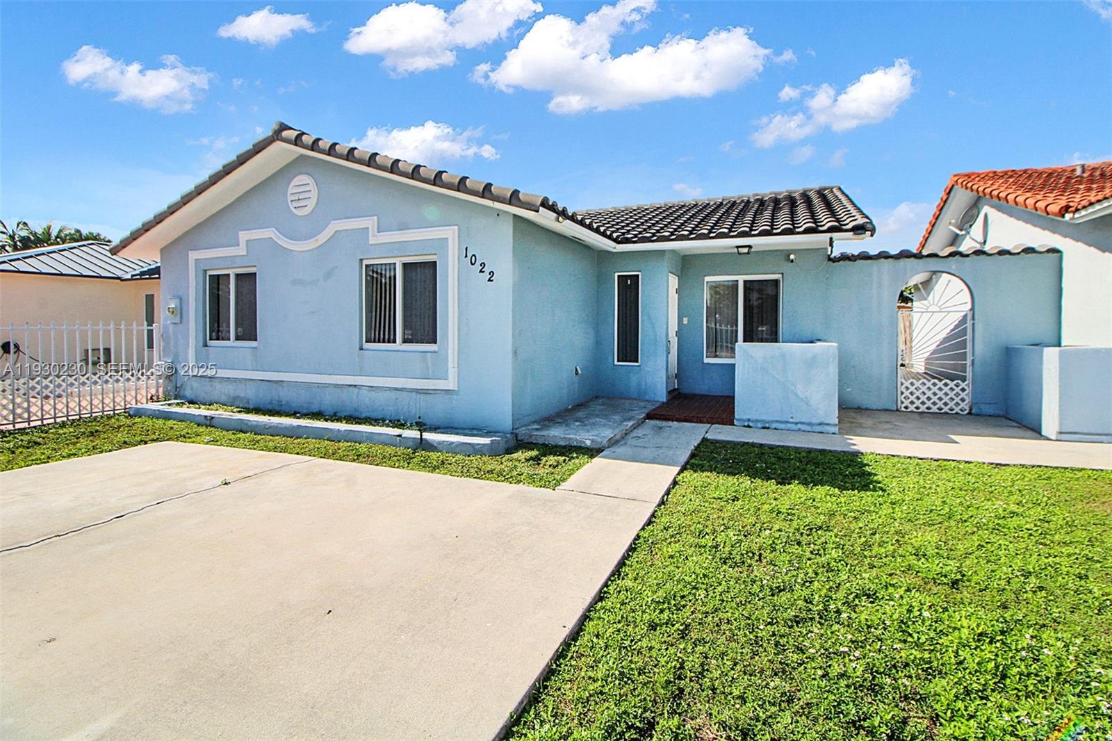 1022 Southwest 138th Place Miami, FL 33184 - Photo 5 of 39 a front view of a house with garden