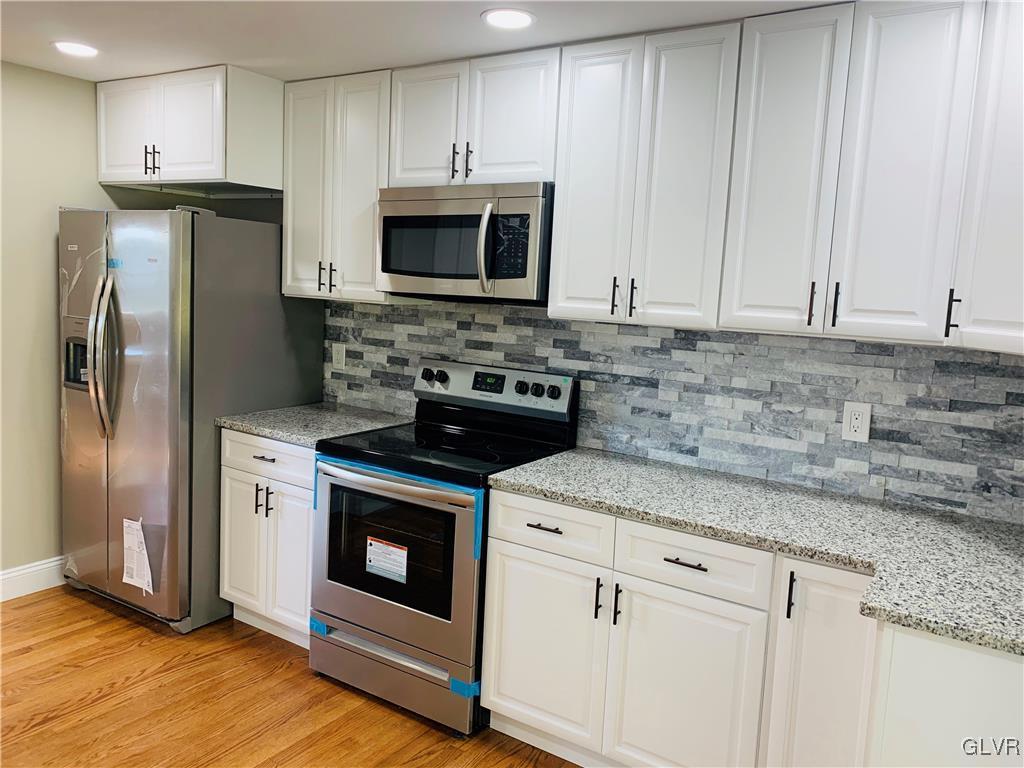 560 Knauss Road Nazareth, PA 18064 - Photo 8 of 25 a kitchen with stainless steel appliances granite countertop a stove a refrigerator and a microwave