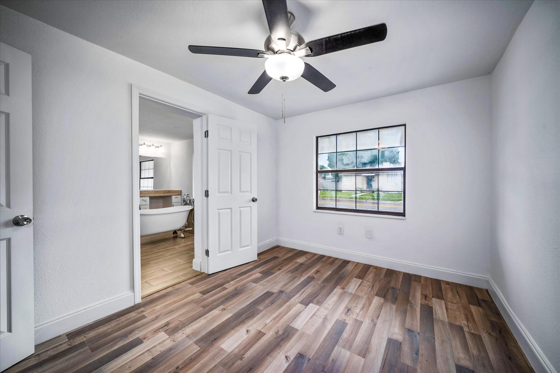 300 East Fee Avenue Melbourne, FL 32901 - Photo 11 of 27 wooden floor in an empty room with a window