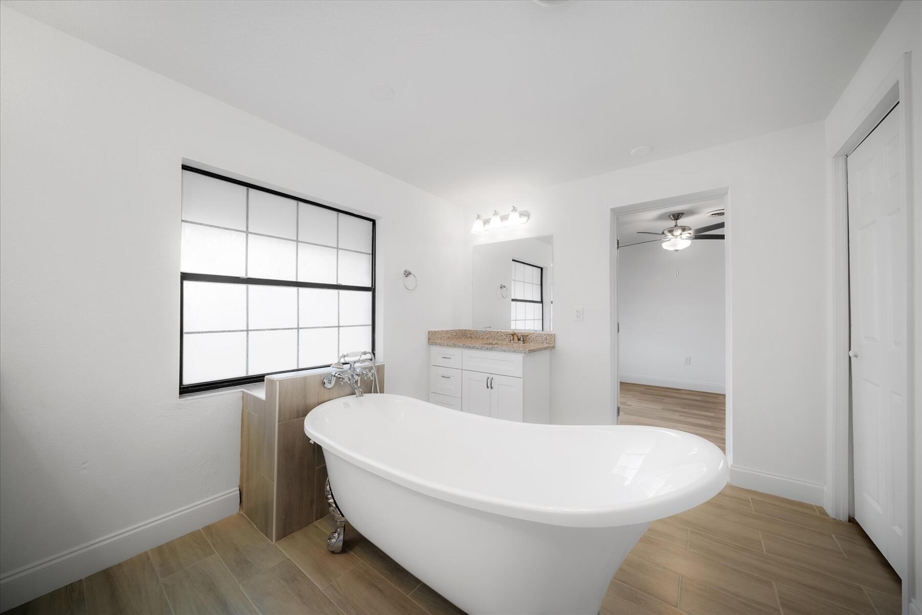 300 East Fee Avenue Melbourne, FL 32901 - Photo 13 of 27 a white tub sitting in a bathroom next to a window