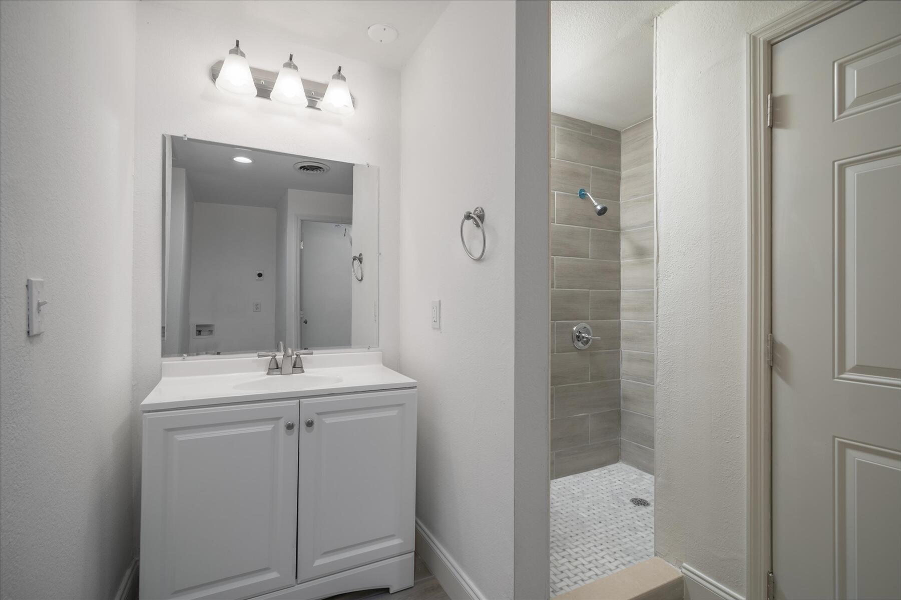 300 East Fee Avenue Melbourne, FL 32901 - Photo 19 of 27 a bathroom with a sink a light fixture and a mirror