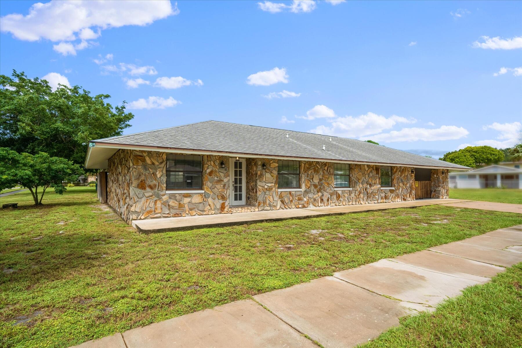 300 East Fee Avenue Melbourne, FL 32901 - Photo 2 of 27 a front view of a house with garden