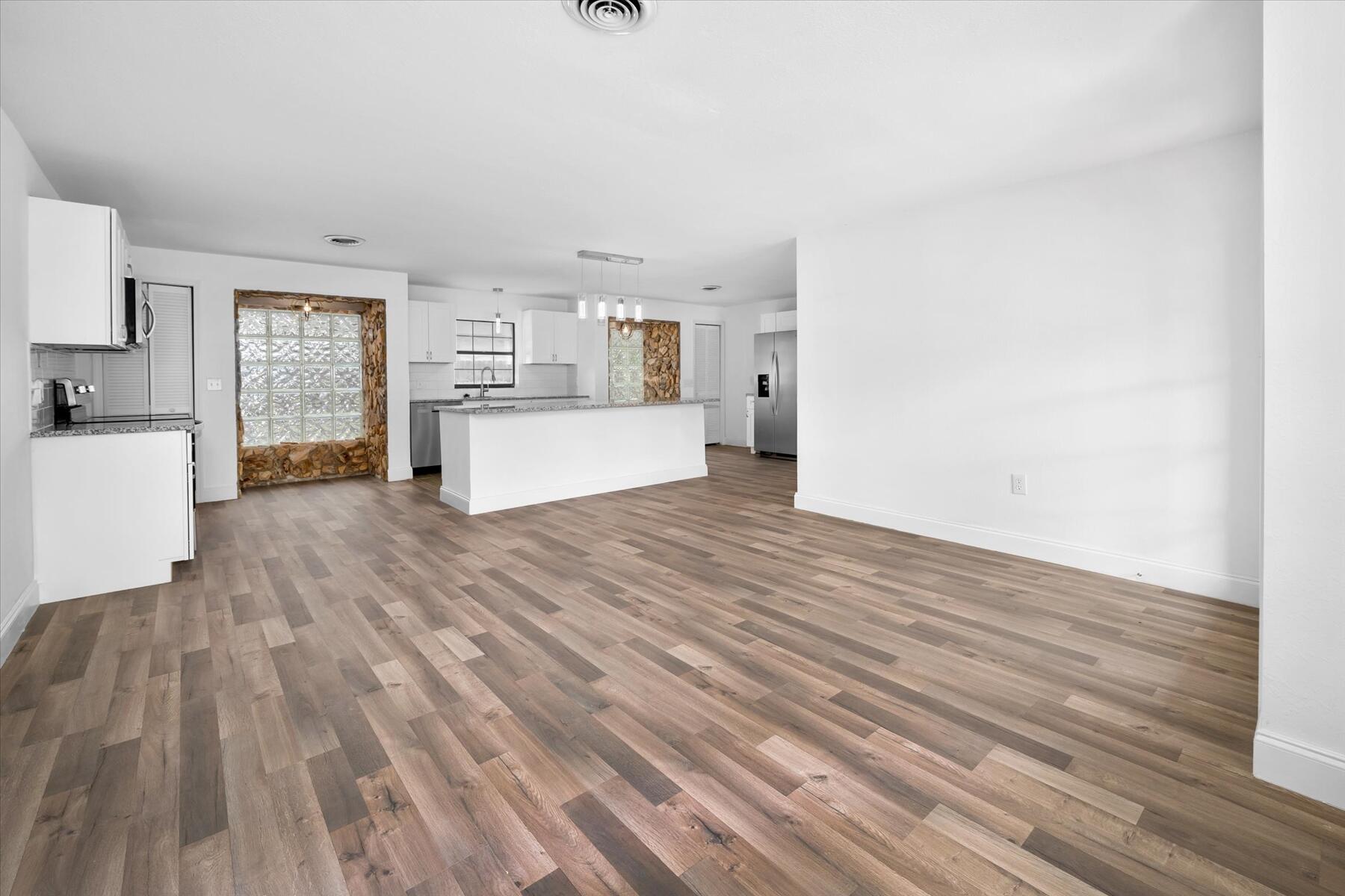 300 East Fee Avenue Melbourne, FL 32901 - Photo 5 of 27 a room with a bed and wooden floor