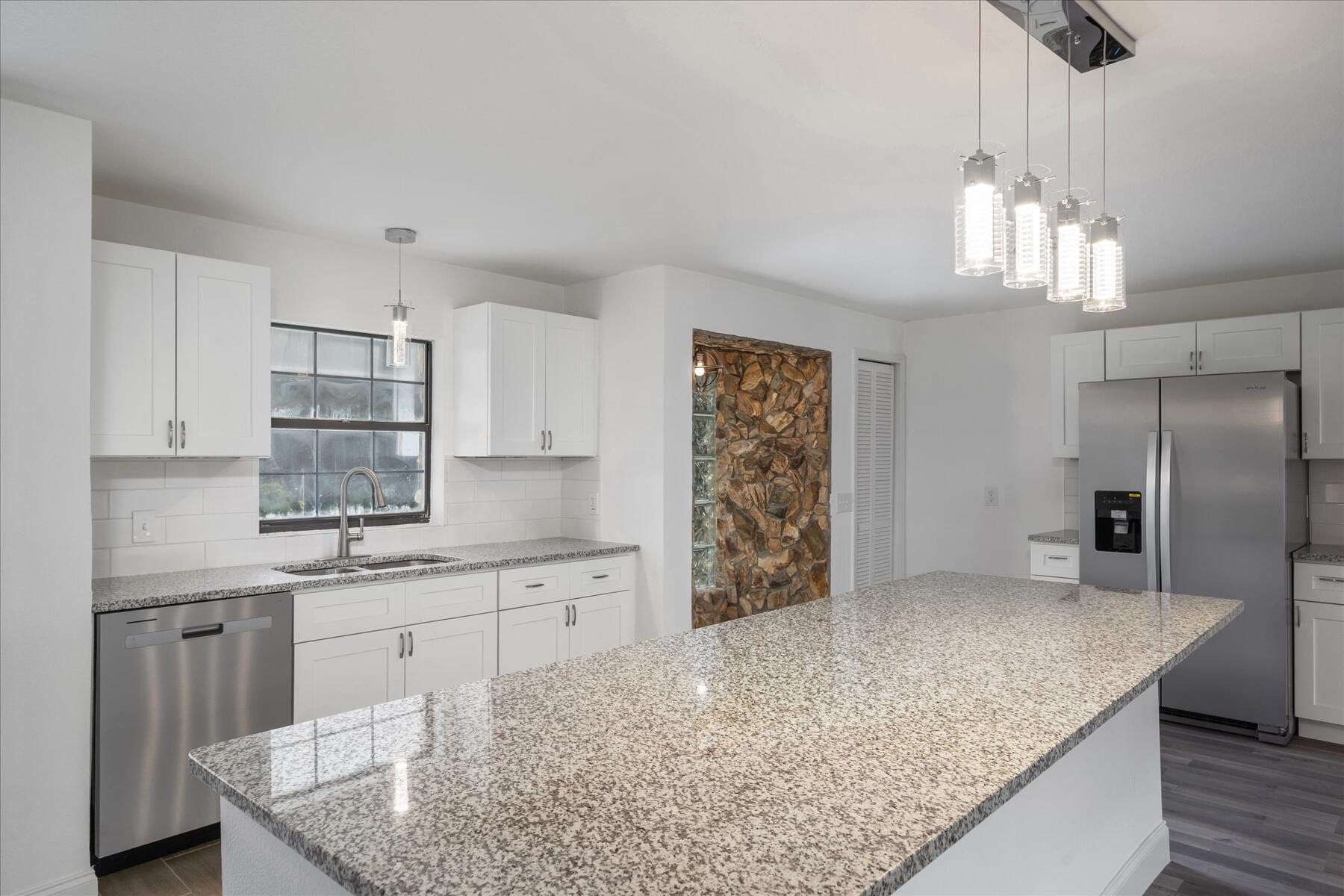 300 East Fee Avenue Melbourne, FL 32901 - Photo 8 of 27 a kitchen with stainless steel appliances granite countertop a sink a stove and a refrigerator