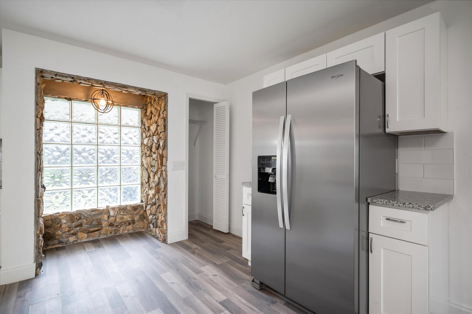 300 East Fee Avenue Melbourne, FL 32901 - Photo 9 of 27 a kitchen with a refrigerator and wooden floor