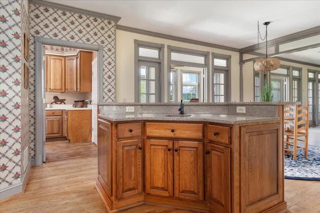 a living room with kitchen island furniture and a chandelier