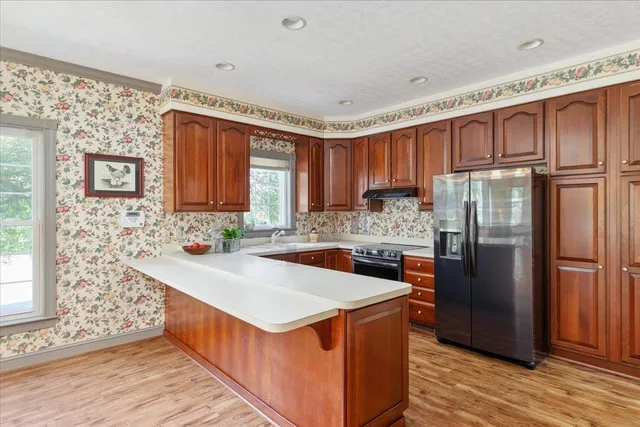 a view of an entryway with wooden floor and windows