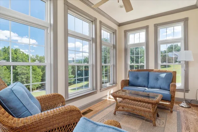 a view of an empty room with furniture and a window