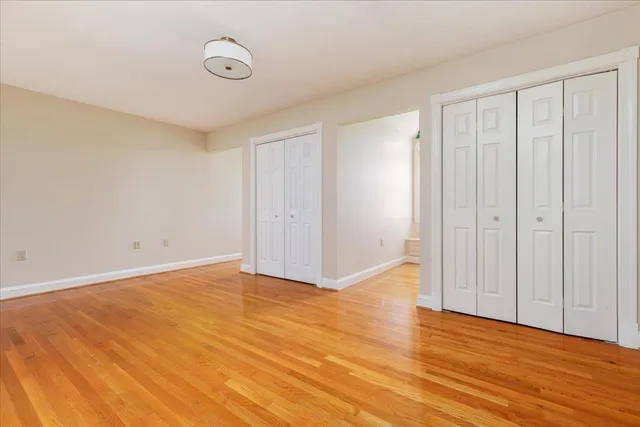 a living room with a fireplace and a painting on the wall