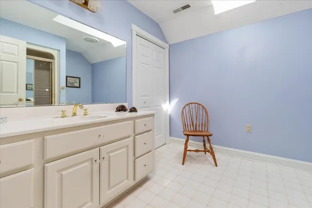 a living room with furniture and a lamp