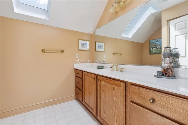 a view of an empty room with a fireplace and a window
