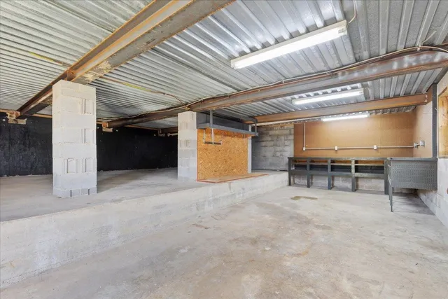 a view of a house with a big yard plants and large trees