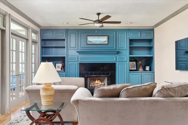 a living room with furniture a window and a fireplace