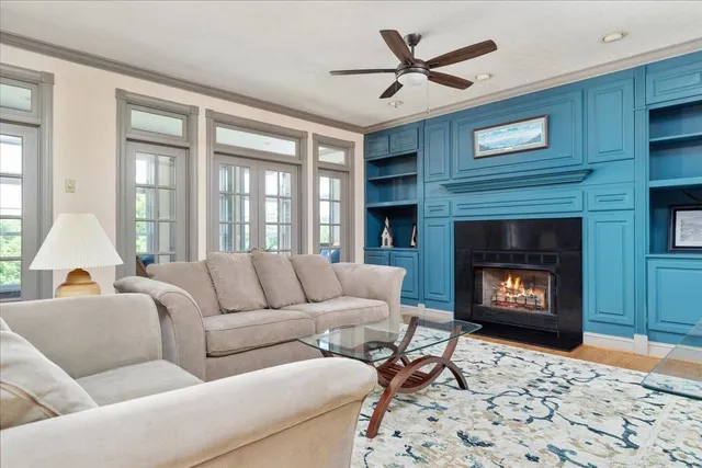a living room with furniture a fireplace and a flat screen tv