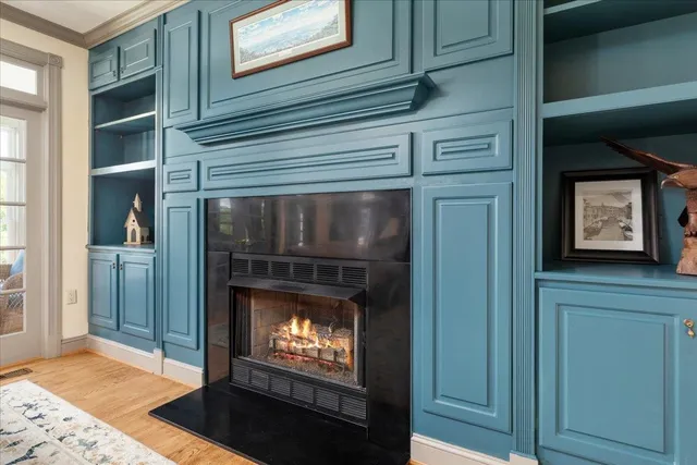 a dining room with furniture a chandelier and wooden floor