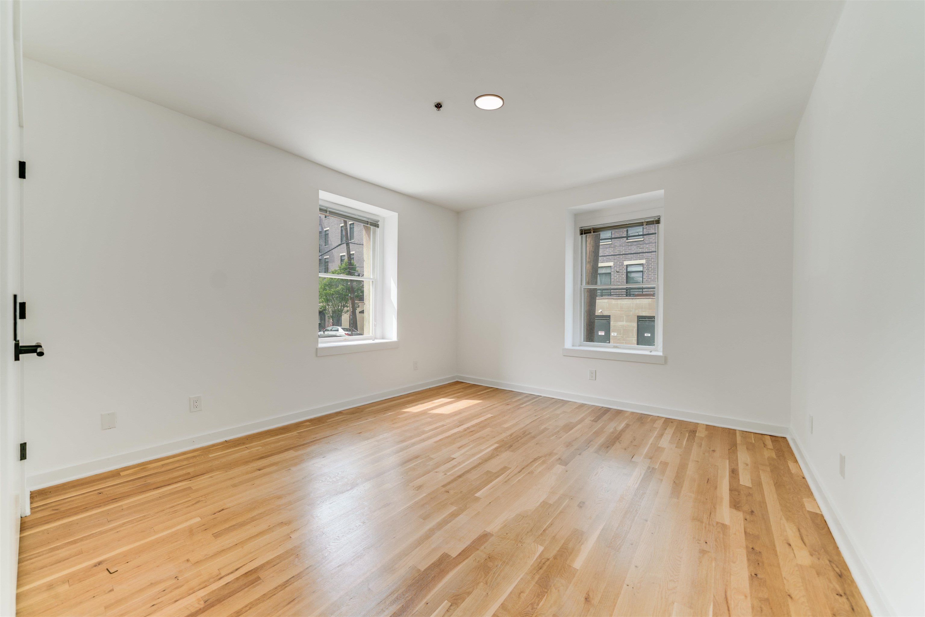 716 Madison Street, Unit 110 Hoboken, NJ 07030 - Photo 10 of 15 a view of empty room with wooden floor and fan