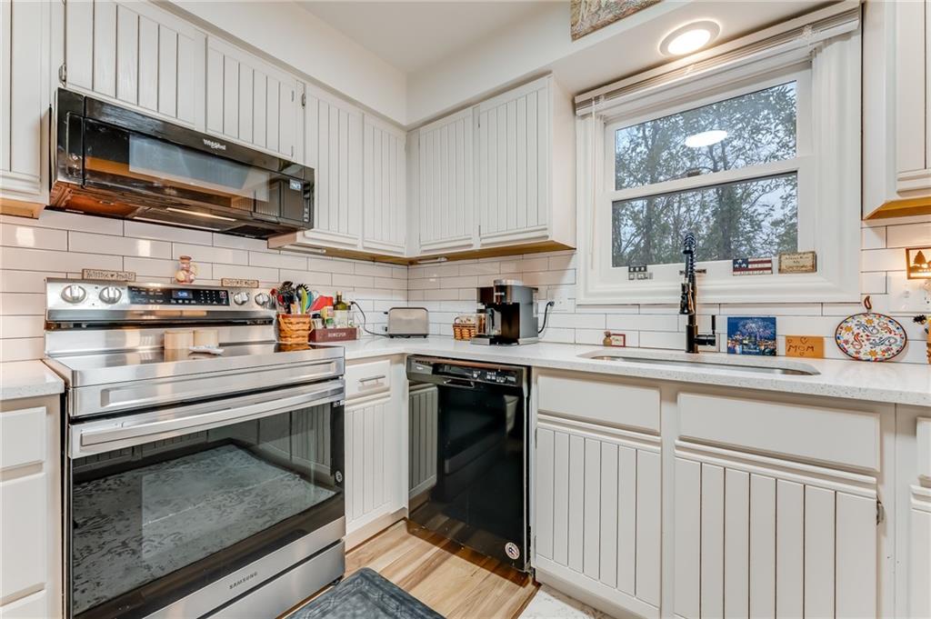 412 Chandler Place Pittsburgh, PA 15212 - Photo 12 of 49 a kitchen with stainless steel appliances granite countertop a stove microwave and sink