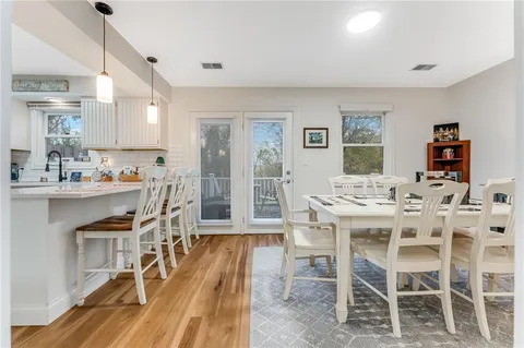 a kitchen with granite countertop stainless steel appliances a refrigerator a stove top oven and a center island