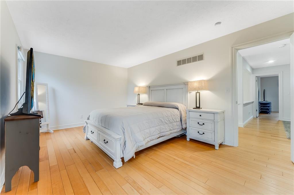412 Chandler Place Pittsburgh, PA 15212 - Photo 22 of 49 a bedroom with a bed and a flat tv screen on dresser