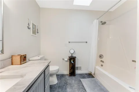 a view of walk in closet with clothes