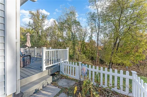 a view of a deck with couches and wooden floor