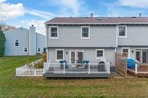 a view of a house with backyard and deck