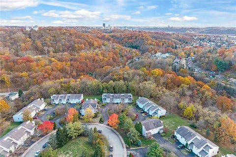 an aerial view of a house with a swimming pool