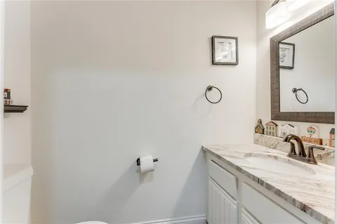 a kitchen with granite countertop a refrigerator stove and sink