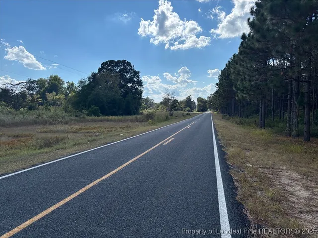a view of a yard with brick walls