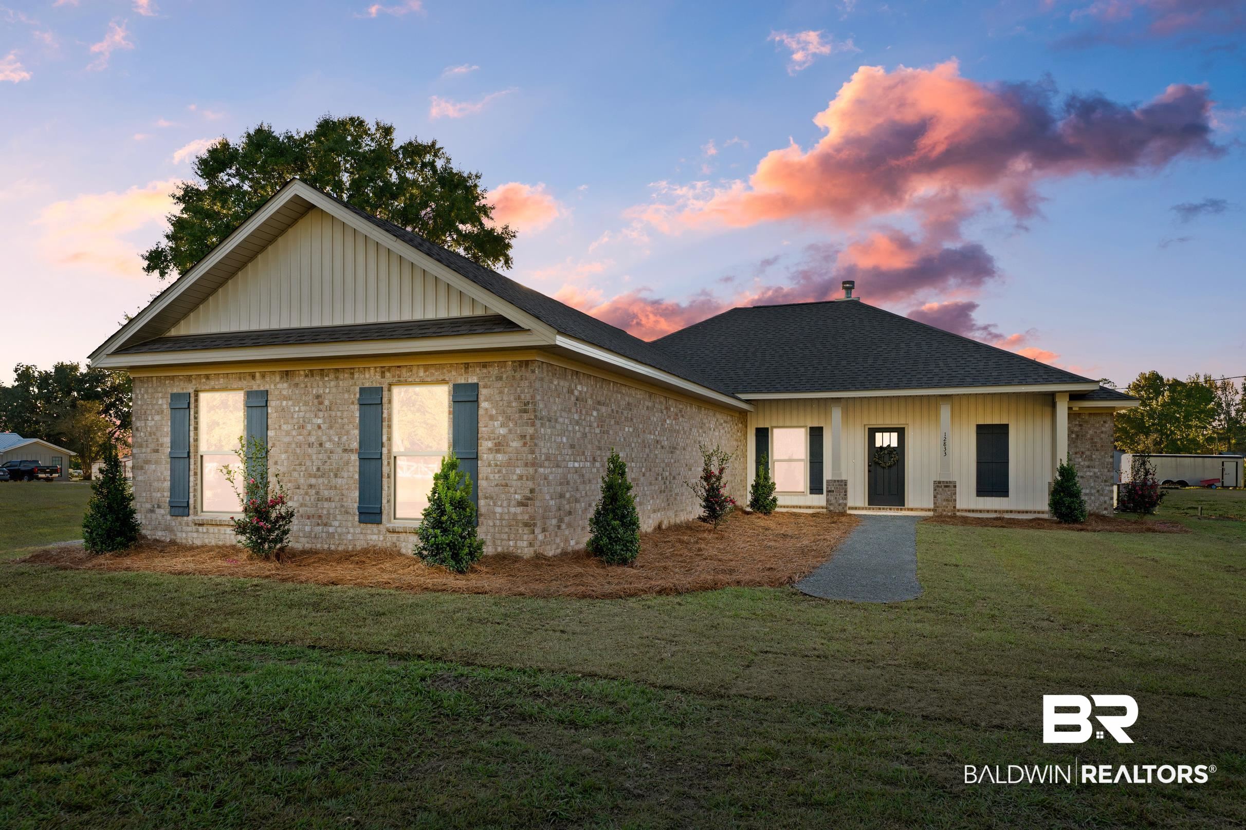 12833 Ward Road West Stapleton, AL 36578 - Photo 2 of 27 View of front of property with a front lawn, brick siding, a porch, board and batten siding, and roof with shingles