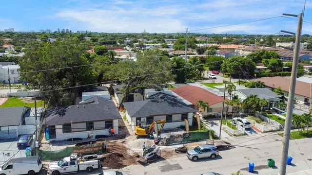 an aerial view of houses with a swimming pool